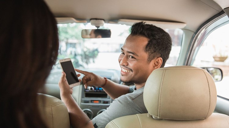 uber driving giving a lift to a passenger